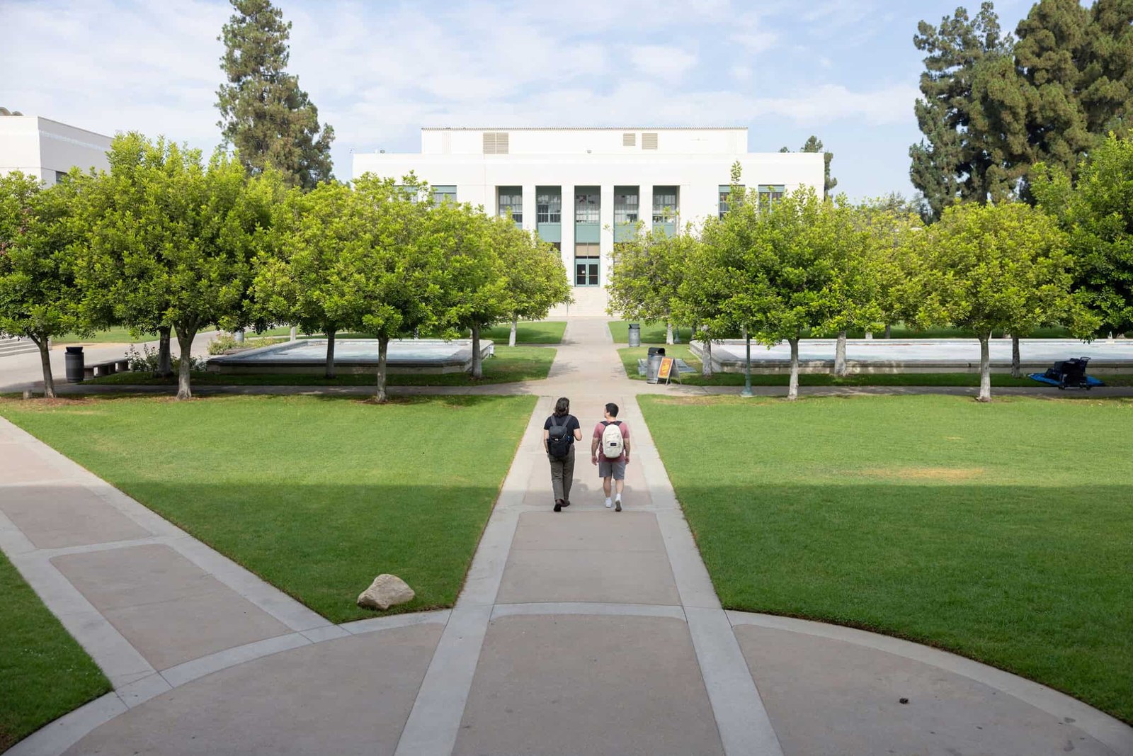 Students walking across the TCST campus quad